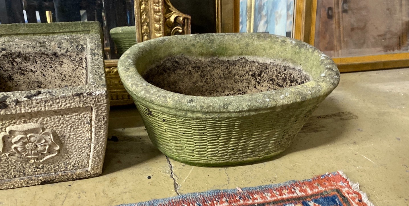 A pair of square reconstituted stone garden planters, height 19cm and a larger oval planter